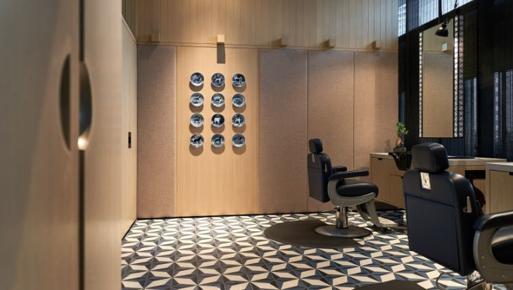  Elegant grooming area at Truefitt & Hill at Kuala Lumpur, featuring high-end barber chairs and a stylish, modern interior.