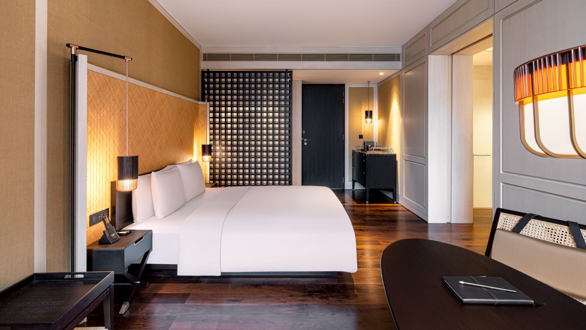 Twin bed & lounge in Deluxe Room at The RuMa Hotel & Residences